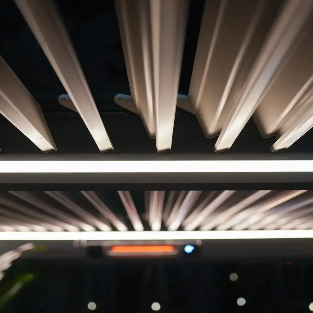 Warm-white LED kit illuminating pergola louvers at night